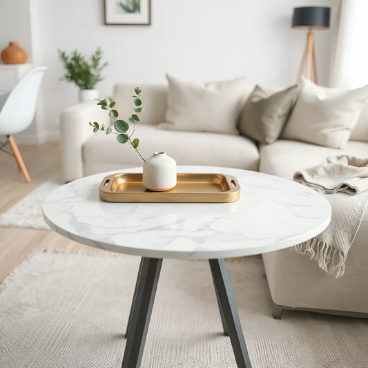 Polished marble tabletop styled with a neutral vase, linen napkin, and small brass accent in a bright room.