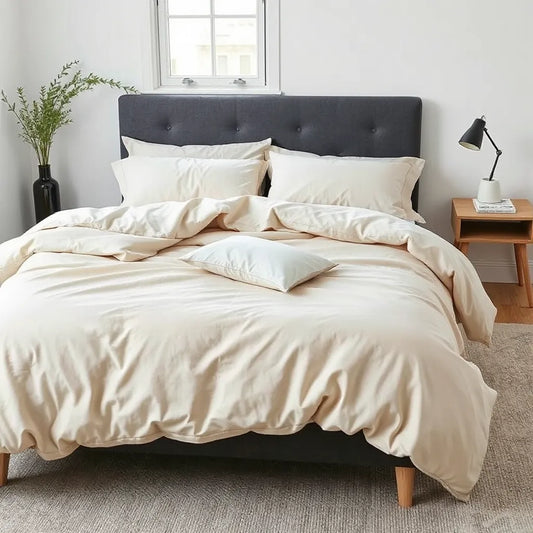 King-size bed with a neatly made duvet cover set in a modern, neutral bedroom setting